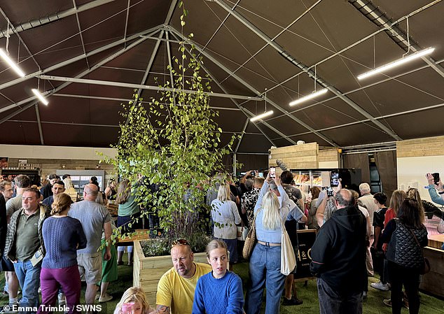 People wait to be served at Clarkson's pub on its opening day