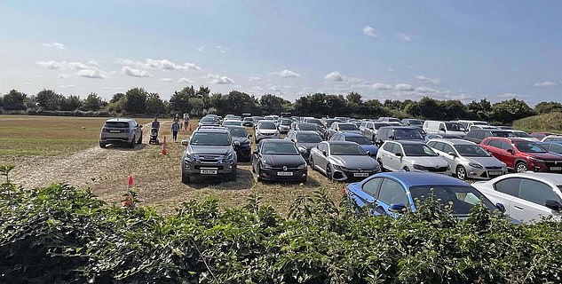 The overflow field runs along the A40 Burford Road and has a capacity of around 2,000 cars, according to the parking attendants working there