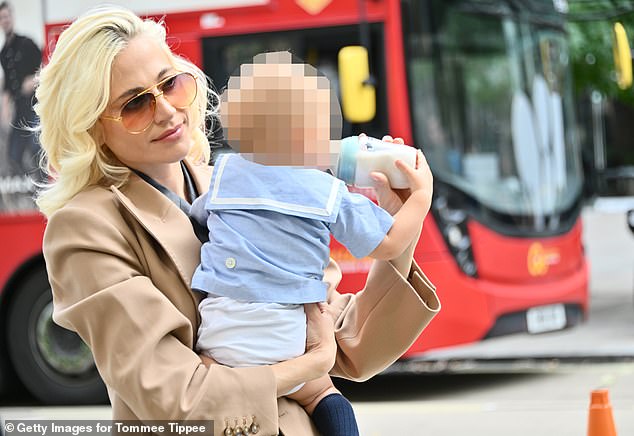 However, the singer appears to have traded in the club nights and is now a working mother, as she was pictured today feeding her 10-month-old son while on the go between shows at London Fashion Week (pictured)