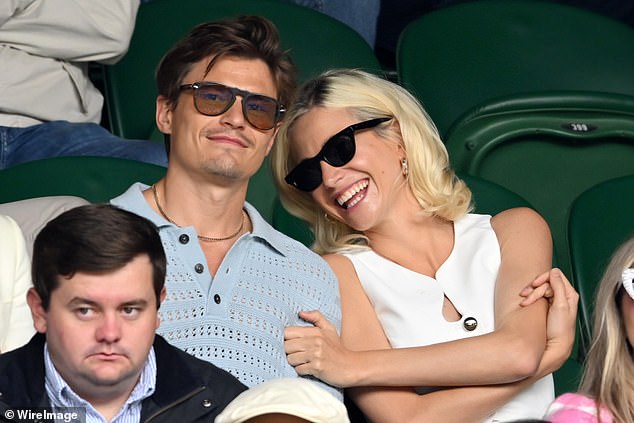 The singer and actress met her now husband, the model Oliver Cheshire, 36, a year after shooting to fame at a catwalk show in 2010 and they got engaged in 2016, married in 2022 and then welcomed their son in November (pictured together at Wimbledon in July)