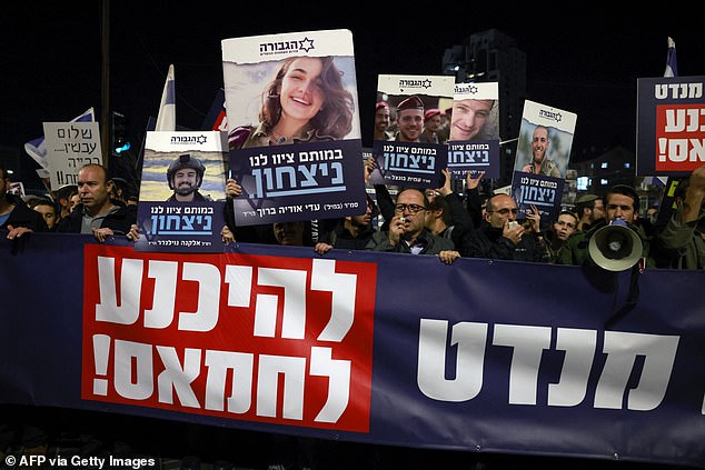 Right wing Israelis hold images of fallen soldiers during a march in Jerusalem rejecting a potential deal with Hamas, on January 13