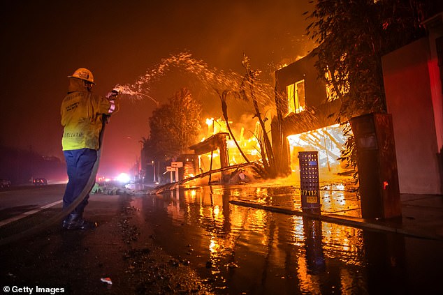 A firefighter battled the Palisades Fire as it burned homes on Pacific Coast Highway January 8