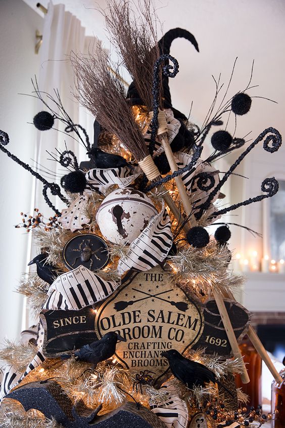 A vintage Halloween tree in black and white, with vintage signs, bells, brooms and a witch's hat plus some blackbirds is cool.