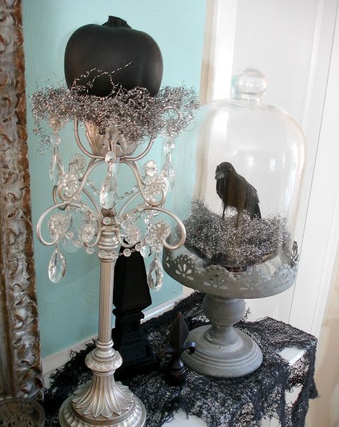 Vintage Halloween decor with a tall stand and a cloche, crystals, shiny hay, a black pumpkins and a blackbird is a beautiful idea to DIY.