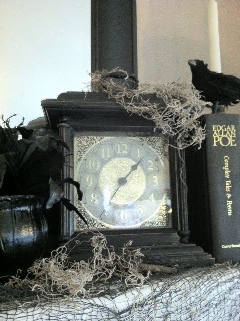 A black vintage clock with moss and a blackbird is a lovely decor idea for a vintage Halloween party.