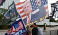 Trump supporters wave a flag bearing his likeness.