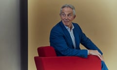 Tony Blair sitting in a red armchair