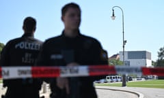 Two police officers in the foreground with the Nazi documentation centre in the background