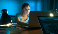 Beautiful woman working late at night in office, surfing the web and writing post on social network with laptop computer. The gi<br>ER4RGH Beautiful woman working late at night in office, surfing the web and writing post on social network with laptop computer. The gi