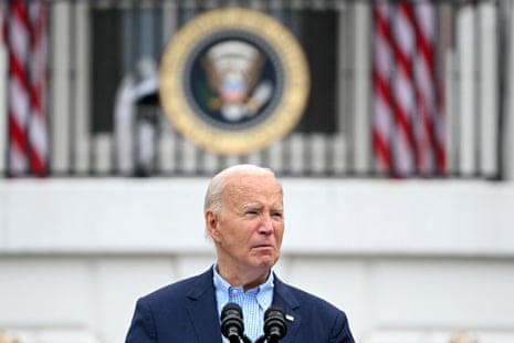 a man in a blue suit looks out from behind a lectern