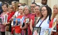 Relatives of those who died of Covid-19 stand outside the inquiry holding pictures of their loved ones