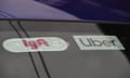 Lyft and Uber stickers on a car's windshield