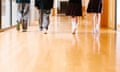 Four students walk through corridor