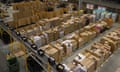 View from above of the interior of a large warehouse, showing huge stacks of boxes