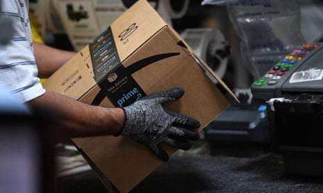 An amazon worker holds a box