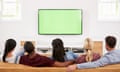 Young people watching television together