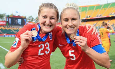 Ellen White and Steph Houghton wearing England kits and holding bronze medals at the 2015 Women’s World Cup.