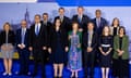 Men and women in suits and formal attire stand together at a treaty signing ceremony