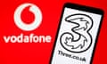 The Vodafone and Three logos.