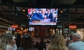 people watch TV screen at a bar