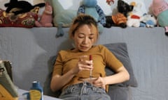 A woman holds a needle to inject herself to prepare for fertility treatment