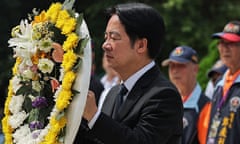 Taiwanese president Lai Ching-te holds a floral tribute during a ceremony