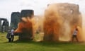 An image taken from a video released by the Just Stop Oil climate campaign group shows activists spraying orange powder paint at Stonehenge in Wiltshire.