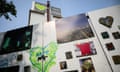 Messages of support and grief written on hoardings around the shrouded structure of Grenfell Tower