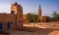 Two mud-brick buildings with blue doors