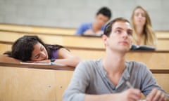 Students listening a lecturer while their classmate is sleeping<br>C8RAK1 Students listening a lecturer while their classmate is sleeping