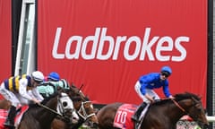 Ladbrokes sign behind finish line at a horse race