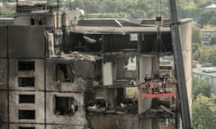 Ukrainian emergency workers inspect a heavily damaged residential building following a recent missile attack in Kharkiv.