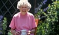 An elderly woman having a cup of tea in a garden