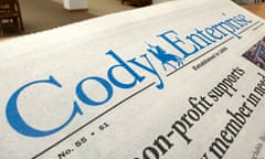 A close-up of a newspaper with a blue masthead reading 'Cody Enterprise'