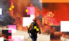 A firefighter walks towards a huge wildfire.