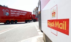 a large red-coloured royal mail lorry pulls into a depot with the courier's logo on the gate in the foreground