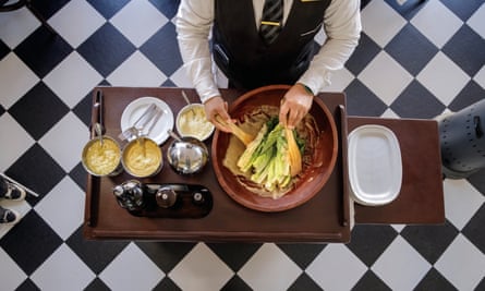 someone makes a salad on a table