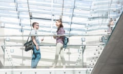 Two students walking on skywalk at university library<br>ETW3PB Two students walking on skywalk at university library