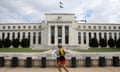 FILE PHOTO: A jogger runs past the Federal Reserve building in Washington, DC, U.S., August 22, 2018. REUTERS/Chris Wattie/File Photo