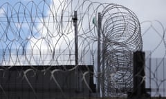 Coils of barbed wire on prison wall