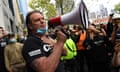 John Setka in a black CFMEU t-shirt holds megaphone, surrounded by union members