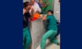 Healthcare workers in green barricading door with filing cabinet