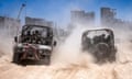 Israeli army vehicles transport a group of soldiers and journalists inside southern Gaza in early July.