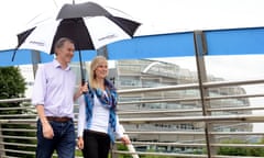 man and woman walking on bridge