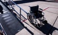 A wheelchair beside a ramp at an airport