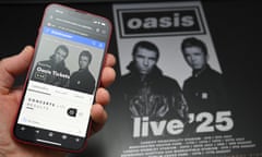 A fan uses a smartphone to access an online ticket sales website to buy Oasis tickets