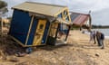 People inspect damaged bathing boxes at Shire Hall beach in Mornington