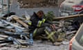 Ukrainian rescuer amid debris from the Russian attack on Lviv