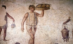 A 2nd century mosaic shows people carrying loaves of bread and ancient stoves