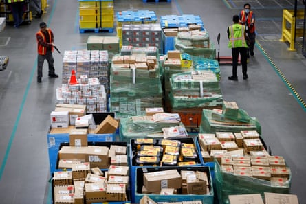 Workers move goods at Amazon’s fulfillment center in Robbinsville, New Jersey.